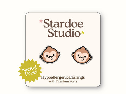 Small monkey face glossy stud earrings jewelry with brown fur and cute primate expressions representing beloved jungle creatures that animal lovers and zoo enthusiasts adore showcasing wildlife appreciation and primate personality secured with hypoallergenic titanium posts