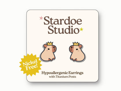 Little capybara stud earrings. These earrings are specifically two identical adorable capybaras with a gold crown on their heads. These earrings are handmade with hypoallergenic titanium posts animal jewelry for kids and adults.