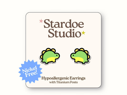 Small handmade dinosaur earring studs with colorful prehistoric reptile design, secured with hypoallergenic titanium posts, perfect for kids and adults who love ancient creatures and paleontology accessories. Made with hypoallergenic titanium posts.