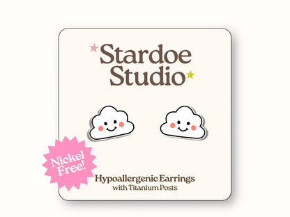 Small fluffy white cloud stud earrings jewelry with cheerful smiley faces featuring black dot eyes and curved smile, representing happy weather symbols and positive vibes that sky enthusiasts and sunshine lovers adore, showcasing kawaii weather aesthetics and joyful expressions, secured with hypoallergenic titanium posts, perfect for girls and boys who love cute weather accessories and uplifting mood jewelry