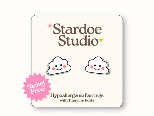 Small fluffy white cloud stud earrings jewelry with cheerful smiley faces featuring black dot eyes and curved smile, representing happy weather symbols and positive vibes that sky enthusiasts and sunshine lovers adore, showcasing kawaii weather aesthetics and joyful expressions, secured with hypoallergenic titanium posts, perfect for girls and boys who love cute weather accessories and uplifting mood jewelry
