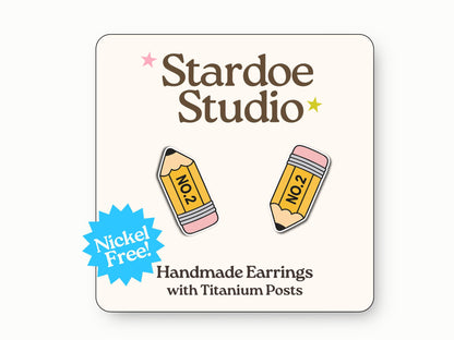 Small handmade pencil earring studs with yellow wood and pink eraser details, secured with hypoallergenic titanium posts, perfect for kids who love school supplies and educational accessories. Made with hypoallergenic titanium posts.