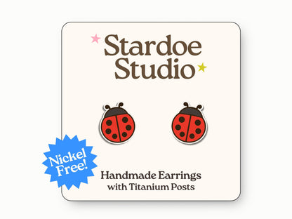 Little ladybug stud earrings featuring a red and black ladybug design. These earrings are handmade with hypoallergenic titanium posts animal jewelry for kids and adults.