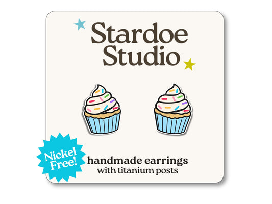 Little blue cupcake stud earrings featuring a cute frosted cupcake design. These earrings are hypoallergenic titanium posts dessert jewelry for kids and adults