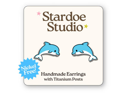 Little dolphin stud earrings featuring an adorable jumping dolphin design. These earrings are hypoallergenic titanium posts cute ocean animal jewelry for kids and adults.