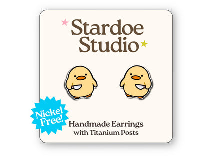 Little duck with knife stud earrings featuring a quirky and mischievous duck design. These earrings are hypoallergenic titanium posts funny animal jewelry for kids and adults.